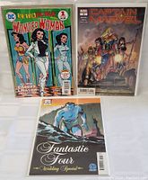 Front covers of Retroactive Wonder Woman 1970s #1, Captain Marvel #1, and Fantastic Four Wedding Special comic books with visible cover art and titles.