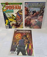 Three Marvel comic books arranged on white surface: The Amazing Spider-Man King-Size Annual #10, Gunhawks #1, and Strikeforce #1. Each comic is in a protective plastic sleeve.