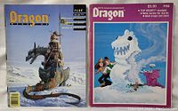 Two Dragon game magazines side by side showing their covers; one with a dragon rider and one with a snow monster scene.