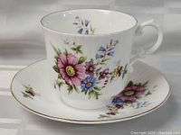 Close-up of Royal Minster tea cup with floral decoration and gold rim