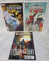 Three Spider-Man comic books displayed flat showing their cover art.