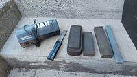 All items displayed together showing the electric sharpener, manual metal file sharpener, and four sharpening stones.