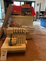 Hobbylock 797 electronic serger front view with plastic bin in background