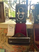 Front view showing twin lenses, shutter controls and leatherette body