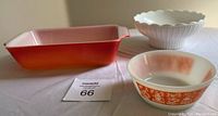 Three vintage dishes: orange rectangular casserole, white and orange bowl, and white milk glass planter with scalloped edges.