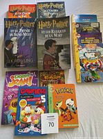 All eleven children's books arranged showing cover titles including Harry Potter, Geronimo Stilton, L-Agent Jean, Garfield, Kaboum, Pokemon.