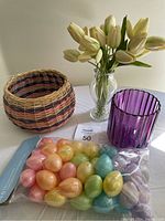 Full lot showing clear vase with white tulips, purple glass vase, wicker basket, and packaged pastel egg containers