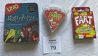 Three sealed new card games: Harry Potter Uno, Pizza Party, Fart - The Explosive Card Game, displayed in photo