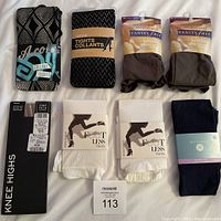 Lot showing assorted tights and knee highs laid out, including footless tights in white and navy.