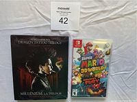 Nintendo Switch Super Mario 3D World + Bowser's Fury game case and Dragon Tattoo Trilogy Extended Edition blu-ray set