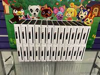 Front view of 24 stacked white Nintendo Wii consoles showing disc slots, power, reset buttons