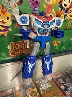 Front view of Optimus Prime Transformer in robot mode showcasing colors and articulated limbs against an Animal Crossing themed background.