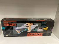 Box for Super Nintendo Super Scope 6 light gun showing front graphics and branding