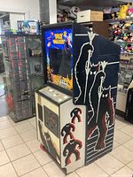 Side view showing vinyl side art of monster and pixel invaders