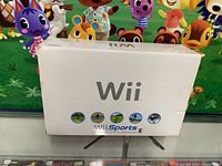 Front view of the white Nintendo Wii console bundle box featuring Wii Sports game icons and branding.