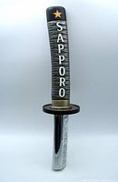 Front view of the Sapporo samurai beer tap pull showing logo and grip detail.