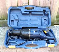 Mastercraft 7.5 amp reciprocating saw inside blue molded plastic carrying case, viewed from above.