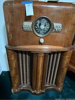 Front view of Zenith floor console radio showing tuning dial, push-buttons and veneer finish