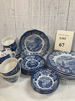 Full set of Royal Warwick blue patterned dishware arranged with plates, bowls, cups, and saucers visible