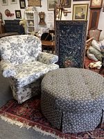 Chair and ottoman displayed together on a rug in showroom