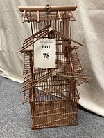 Front full view of the bamboo bird cage showing its 5 tier pagoda style and hanging ring on top