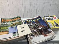 Stack of various vintage magazines including The Family Handyman, Old House Journal and CR Buying Guide focused on woodworking, home improvement and crafts.