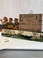 Wooden folk art, Bethlehem Steel crate sign, and primitive farm landscape signs in a group shot showing details and scale.