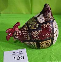 Front side view of the ceramic pecking rooster showing patchwork design and red comb