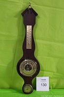 Full view of wooden wall hanger weather station showing thermometer, barometer, and hygrometer