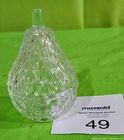 Crystal glass pear-shaped dish with intricate diamond-cut pattern and lid with handle.