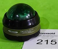 Photo of front side showing the green spherical massage roller with 'Harmony Roller premium edition' label and 'Relaxus' brand on the body.