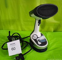 Rowenta X-CEL handheld steamer showing front and power cord with dealership tag.
