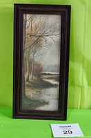 Full view of the framed print showing the artwork and dark wood frame against a green fabric background.