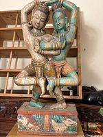 Front view of hand carved Indian couple sculpture showing detailed carving and painted accents.