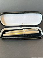 Large silver tone pen and pencil in black velvet case lined with white cushioning.