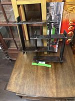 Solid wood wall shelf with multiple staggered compartments shown from front and side angles to depict design and condition.