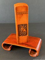 Front view of the rectangular orange Shoushan stone seal showing carved decorative panel with floral or abstract design.