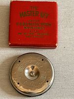 Original red case for The Master Key chromatic pitch instrument with gold lettering.