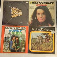 Top four vinyl records visible: KC and the Sunshine Band, Ray Conniff Love Story, Sonny & Cher Look At Us, Blanchard & Morgan album.