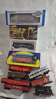 Full set of vintage model trains with some boxed and loose cars visible on white background.