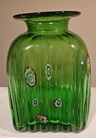 Front view of ribbed green glass bubble vase with millefiori decoration