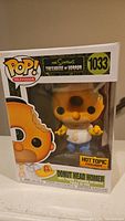 Front view of Funko Pop! box showing Donut Head Homer figure inside, with Hot Topic exclusive sticker and label number 1033.