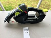 Side view of Bissell Pet Stain Eraser, showing the unit's handle, clear stain tank, and control buttons.