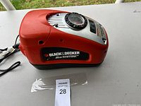 Side view of the Black & Decker Air Station electric air pump showing orange body and side branding.