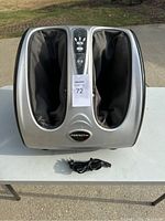 Front view of Perfect Fit foot massager showing two foot compartments with black padded fabric lining and control panel in the center.