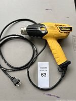 Front and side view of yellow Wagner heat tool with cord laid out on a flat surface showing general condition and power plug.