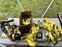 Overview of safety harness, yellow safety straps, metal buckles, hooks, and KwikSafety retractable lifeline.