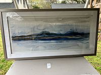 Large framed horizontal watercolor artwork showing an abstract blue and gray landscape scene.
