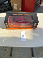 GMC Sierra Denali red radio control truck in original box with torn plastic window showing the truck.