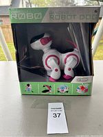 Photo of Vivitar Dancing Robot Dog still in original box, showing front and partial side view of the robot dog and box details.